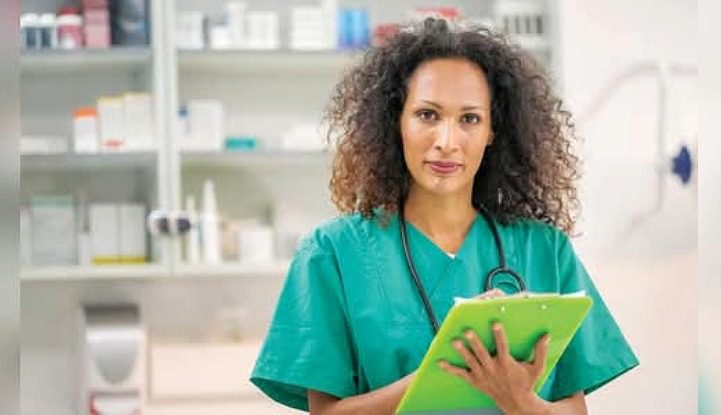 Female Veterinarian writing on clipboard looking at camera
