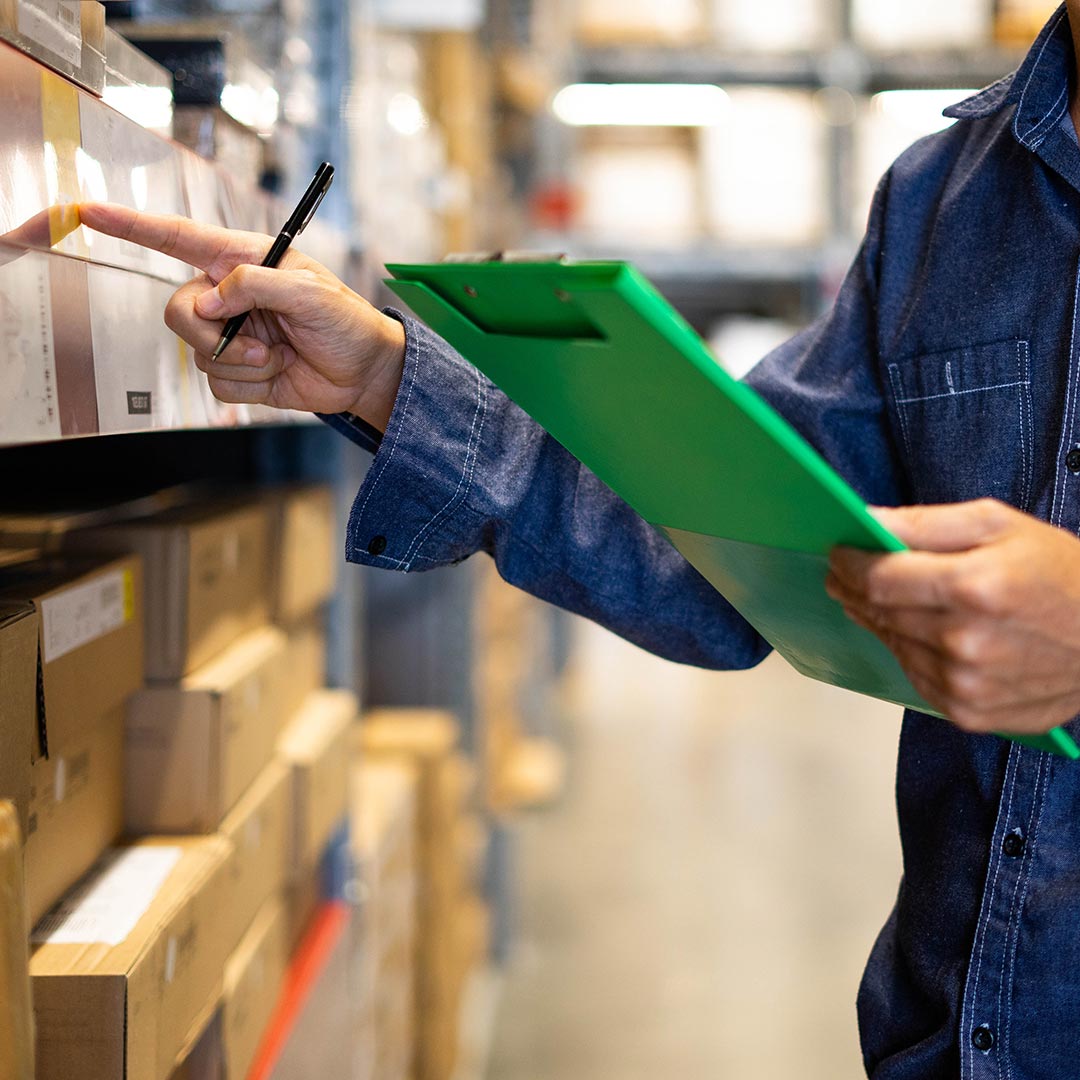 woman checking through inventory using clipboard