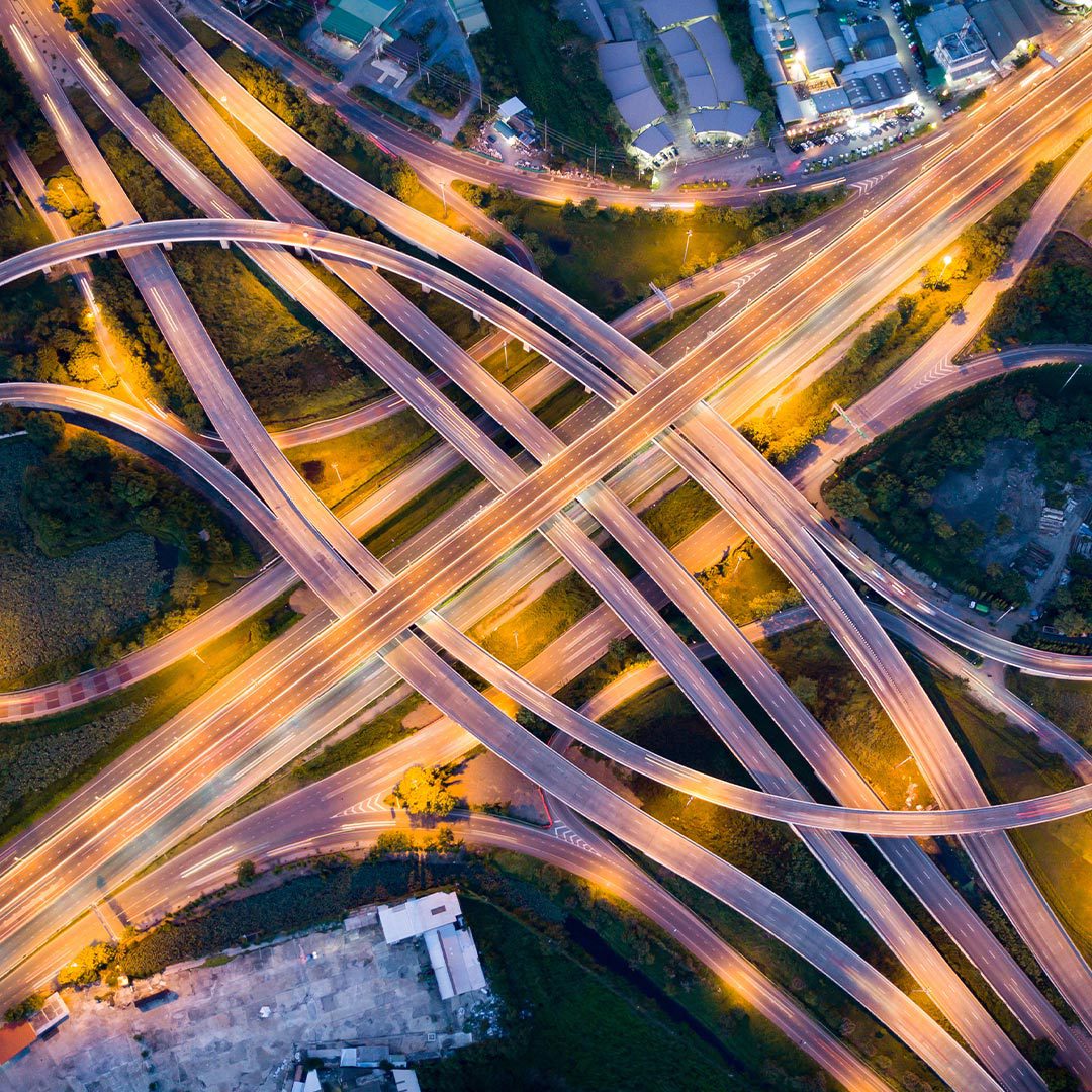 aerial view of illuminated interchange at busy intersection
